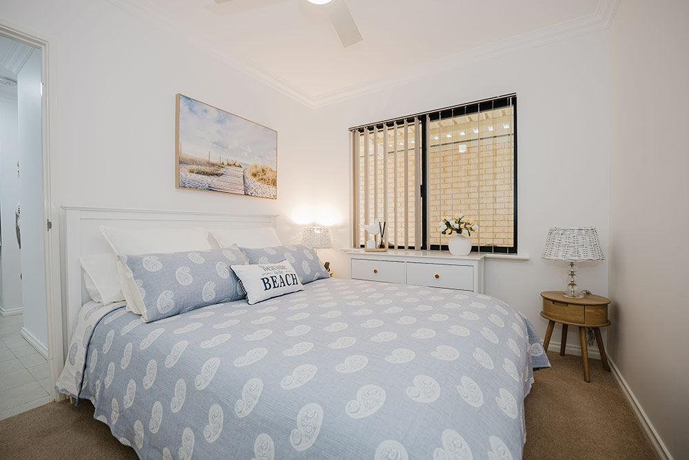 Bedroom with beach decor in a villa in Waratah Community Village
