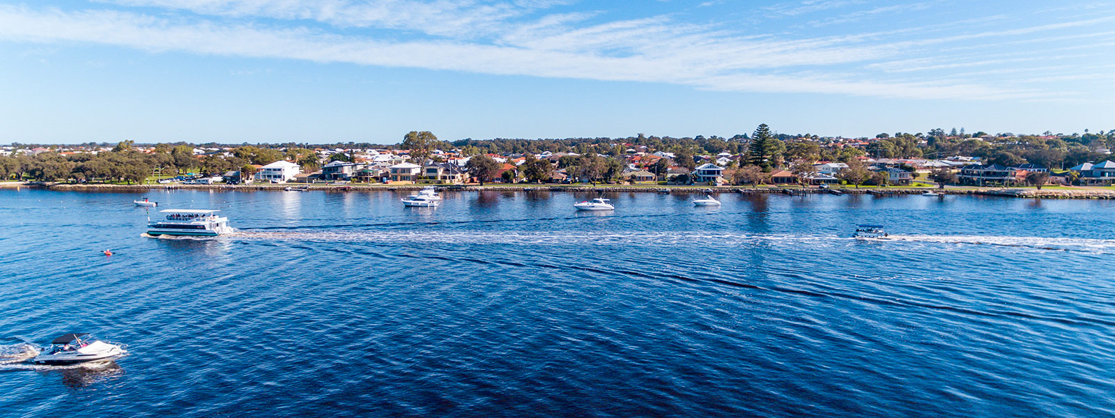 View of blue waters and boats including the Dolphin Cruise boat from Mandurah, Western Australia