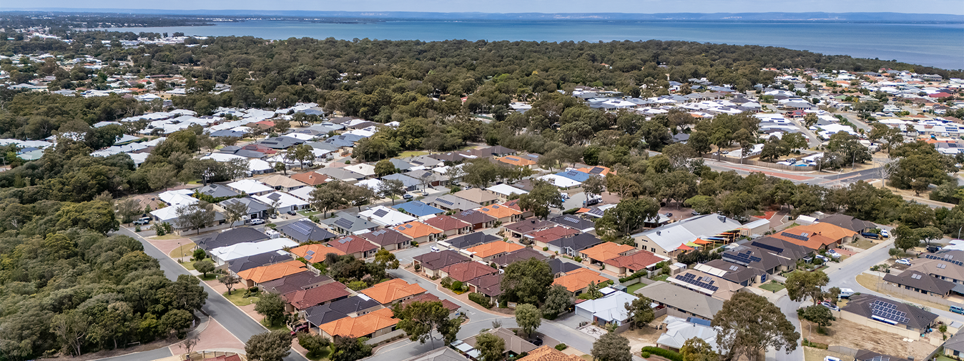 Waratah Community Village drone view of the villas and Mandurah estuary in the distance